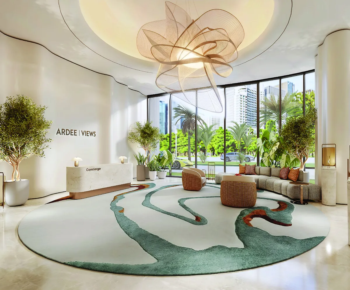 Lobby with sculpted ceiling light and a sea-green rug