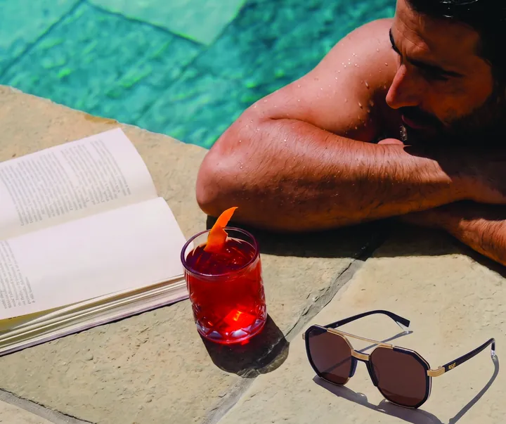 Poolside with a book, a drink and sunglasses
